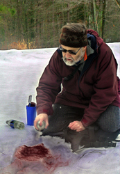 Jim Halfpenny casting grizzly track in snow