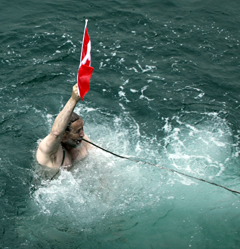 Jim Halfpenny into Arctic ocean with Canadian flag